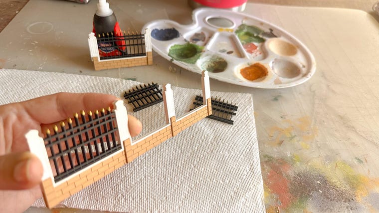 Finishing touches on a completed wooden house replica